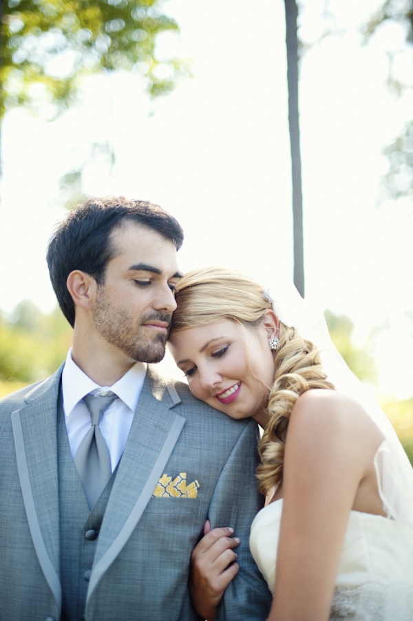 bride and groom in grey suit together outside - wedding photo by top Atlanta based wedding photographers Scobey Photography